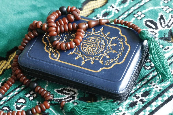 Quran and Islamic prayer beads on a prayer mat, Paris, France, Europe