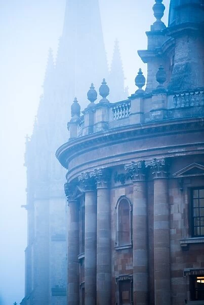 Radcliffe Camera and St. Marys Church in the mist, Oxford, Oxfordshire, England