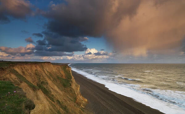 A rain cloud approaches the cliffs at Weybourne, Norfolk, England