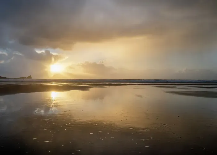 Framed Print : Rain clouds and reflections on Rhossili beach at sunset showing the shipwreck of the Helvetia, Rhossili, Gower, South Wales, United Kingdom, Europe