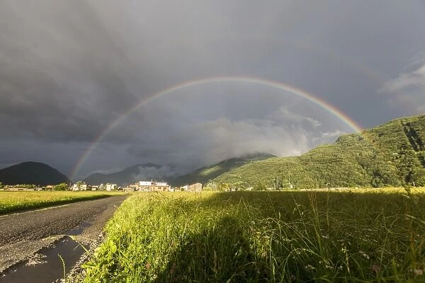 Rainbow over green fields of countryside, Cosio Valtellino, Sondrio province, Valtellina