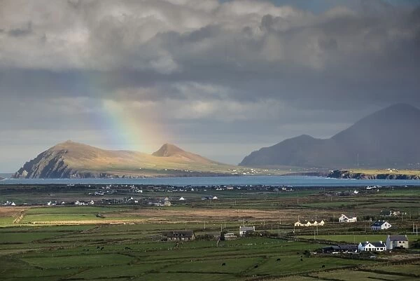 Rainbow over hills and dwellings, looking towards Clogher and Rosroe, Dingle Peninsula