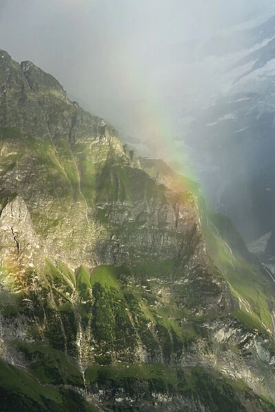 Rainbow over the majestic Wetterhorn mountain in summer, aerial view, Grindelwald