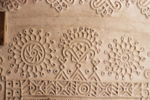 Raised mud reliefs inlaid with mirror on the walls