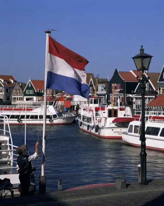 Framed Print : Raising the Dutch flag by the harbour Framed Print : Raising the Dutch flag by the harbour
