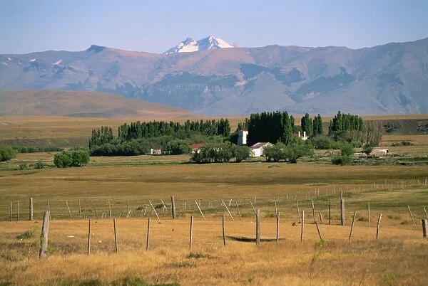 Ranch at Villa Castillo, farmland and mountains behind, in Patagonia, Chile