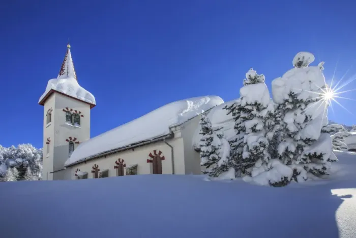 Framed Print : Rays of winter sun illuminate the snowy landscape and the typical church, Maloja Framed Print : Rays of winter sun illuminate the snowy landscape and the typical church, Maloja