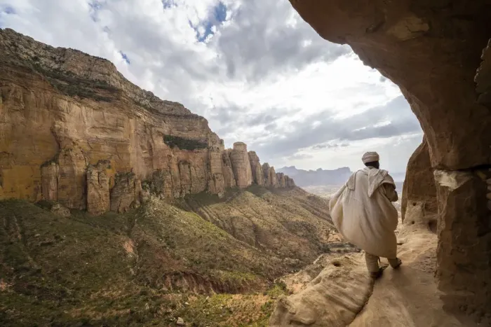 Framed Print : Rear view of priest walking on access trail to the rock-hewn Abuna Yemata Guh church