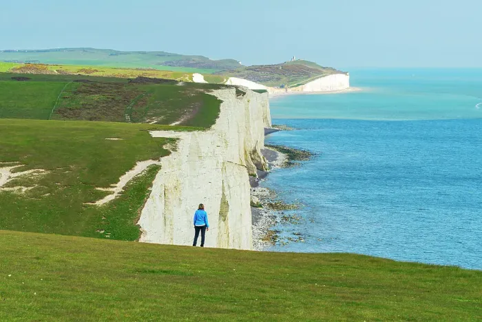 Framed Print : Rear view of woman admiring the view of the coast along the Seven Sisters chalk cliffs, South Downs National Park, East Sussex, England, United Kingdom, Europe Framed Print : Rear view of woman admiring the view of the coast along the Seven Sisters chalk cliffs, South Downs National Park, East Sussex, England, United Kingdom, Europe