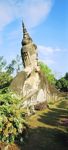 Reclining Buddha statue in the open at Xieng Khuan