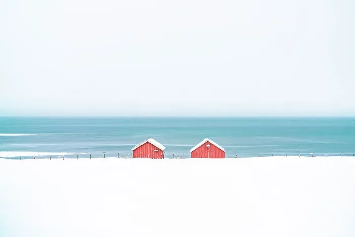 Framed Print : Red cabins in the snow overlooking the frozen sea, Troms county, Norway, Scandinavia, Europe