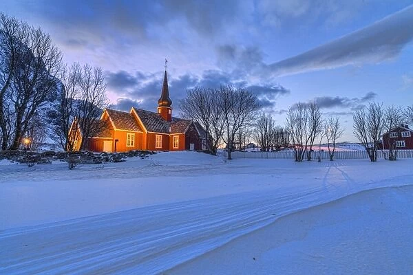 The red church of Flakstad surrounded by snow at dusk, Lofoten Islands, Arctic, Norway