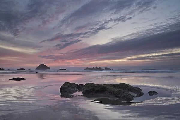 Red clouds, sea stacks, and rocks at sunset, Bandon Beach, Oregon, United States of America, North America