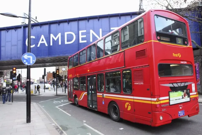 Framed Print : A red double decker bus drives towards the Camden Town area of London, England Framed Print : A red double decker bus drives towards the Camden Town area of London, England