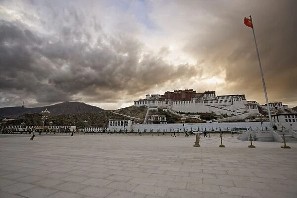 The red flag of China flying in Potala Square on a stormy afternoon in front of the Potala Palace