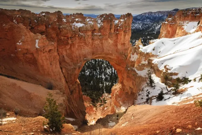 Framed Print : Red-hued limestone arch lit by morning sun with snowy cliffs in winter at Natural Bridge, Bryce Canyon National Park, Utah, United States of America, North America Framed Print : Red-hued limestone arch lit by morning sun with snowy cliffs in winter at Natural Bridge, Bryce Canyon National Park, Utah, United States of America, North America