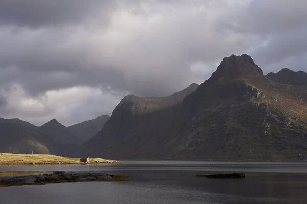 Red hut on bank of Fjord, Lofoten Islands, Norway, Scandinavia, Europe