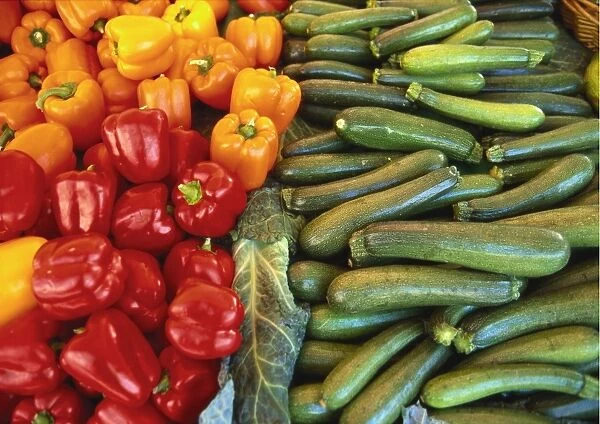 Red Peppers, Yellow Peppers and Courgettes on a Market Stall