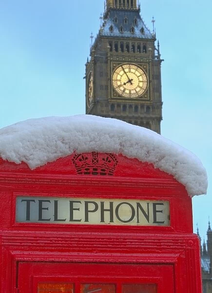 Red phone box and Big Ben in snow, Parliament Square, London, England, United Kingdom, Europe