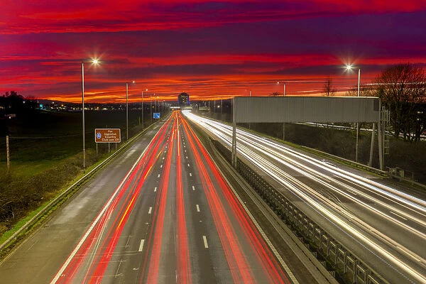 Red sky sunset, traffic light trails, M8 Motorway, Scotland, United Kingdom, Europe