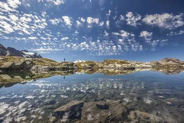 The reflection of the Engadine sky in the the magic of the crystal-clear mountain lakes, Sils, Engadine, Graubunden, Switzerland, Europe