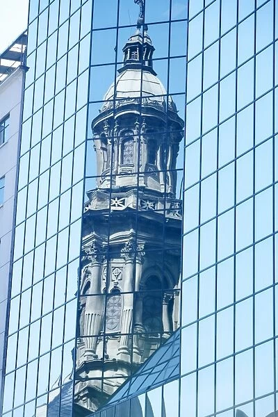 Reflection of the Metropolitan Cathedral in a modern building downtown