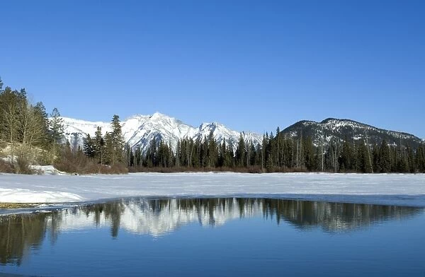 Reflection of Rocky Mountains in Vermilion Lakes in Banff National Park