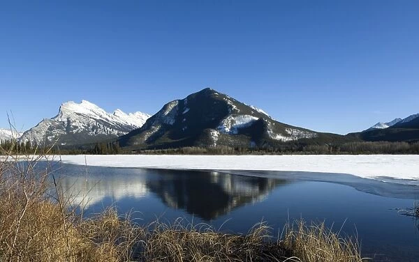 Reflection of Rocky Mountains in Vermilion Lakes in Banff National Park