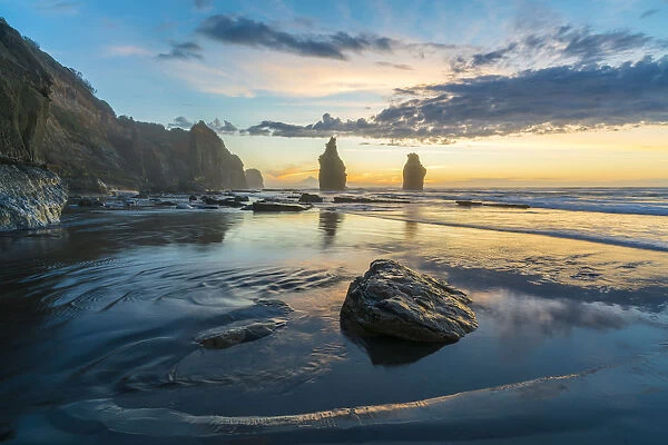 Reflection of the Three Sisters with low tide, at sunset, Tongaporutu, New Plymouth