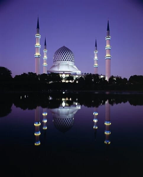 Reflection in tranquil water of the dome and minarets