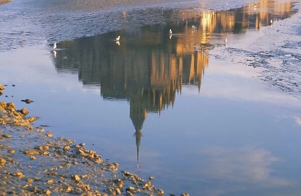 Reflection in water in the early morning of Mont St. Michel, UNESCO World Heritage Site