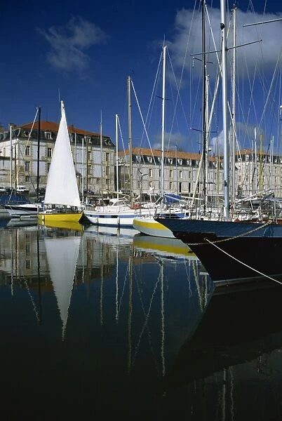Reflections of boats in the marina with the naval storehouse, (Magasin aux Vivres) behind