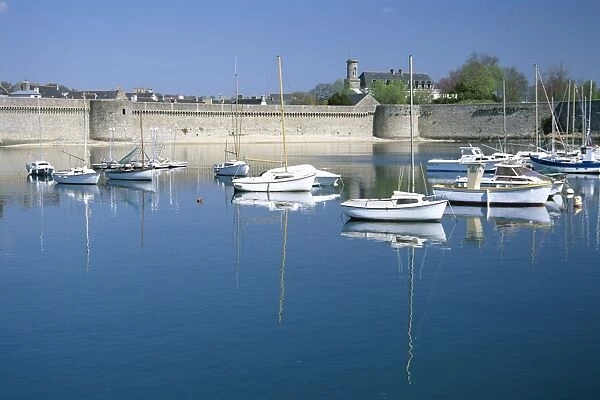Reflections of boats moored in harbour, old walled town, Concarneau, Finistere