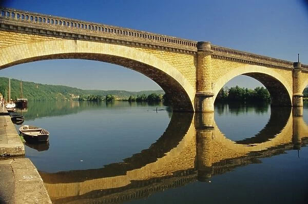 Reflections of a bridge in the River Dordogne, Mauzac, Dordogne, Aquitaine