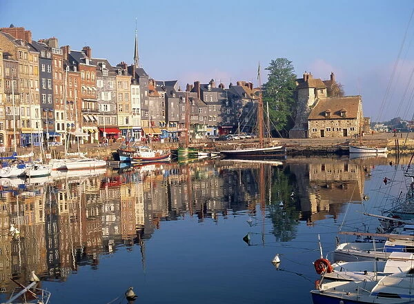 Reflections of houses and boats in the old harbour at Honfleur, Basse Normandie