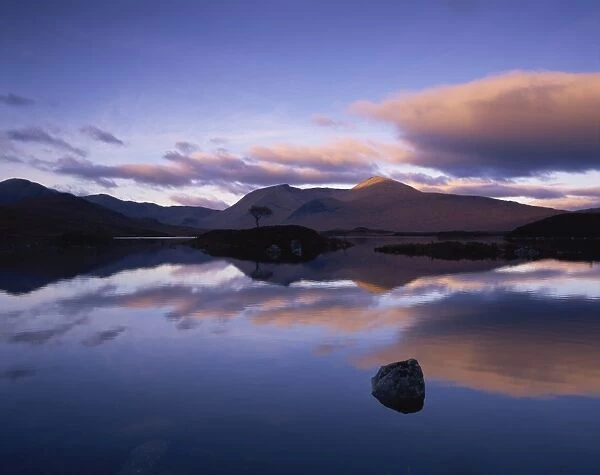 Reflections in Loch Achlaise of clouds and dark hills of Rannoch Moor, in the Highland Region of Scotland, United