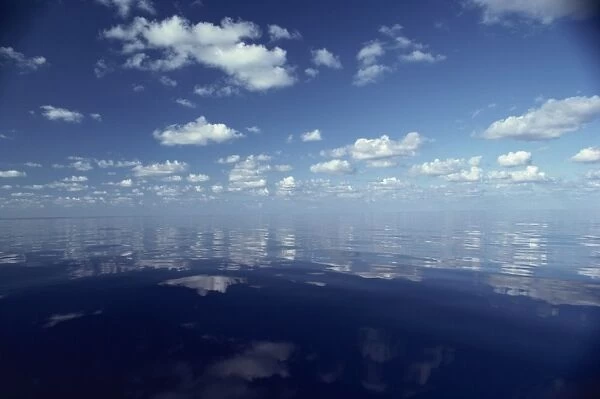 Reflections of white clouds and blue sky in the water