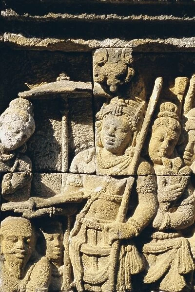 Relief carving on frieze on outside wall of the Buddhist temple