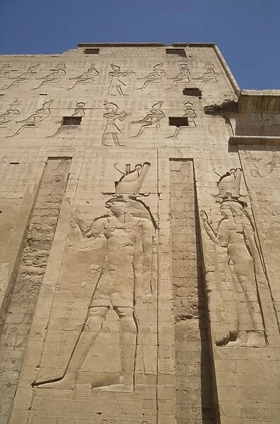 Relief depicting Horus on left, Pylon, Temple of Horus, Edfu, Egypt, North Africa, Africa