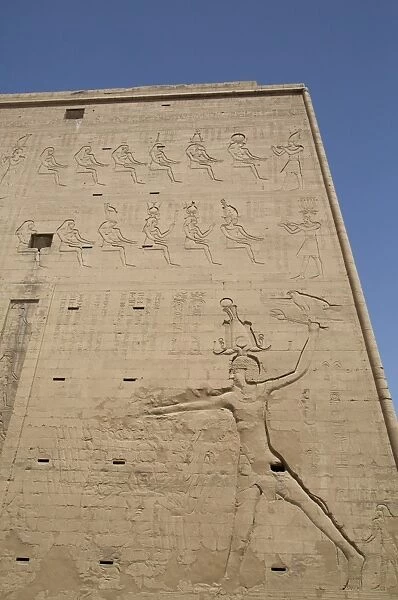 Relief depicting the Pharaoh slaying enemies, Pylon, Temple of Horus, Edfu, Egypt