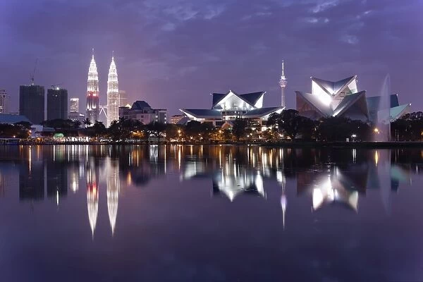 The remarkable Kuala Lumpur skyline, reflected in a lake at Titiwangsa in Kuala Lumpur, Malaysia, Southeast Asia, Asia