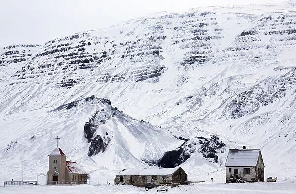 Remote church and farm buildings in snow-covered winter landscape, Snaefellsness Peninsula, Iceland, Polar Regions