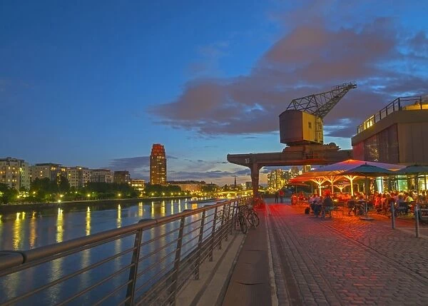 Restaurant beneath old dockyard crane by River Main, Frankfurt-am-Main, Hesse, Germany