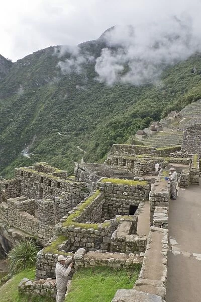 Restoration work at the Inca ruins of Machu Picchu, UNESCO World Heritage Site, Peru
