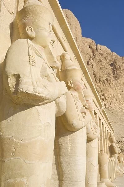 Restored Osirid statues of the female pharaoh Hatshepsut on the pillars of the portico entrance to the third terrace of theTemple of Hatshepsut, Deir el Bahari, West bank of the River Nile, Thebes, UNESCO World Heritage Site, Egypt, North