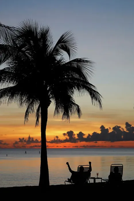 Framed Print : Retired man sitting on a chair at sunset, tropical beach and paradise nature, Cayman Islands, Caribbean, Central America Framed Print : Retired man sitting on a chair at sunset, tropical beach and paradise nature, Cayman Islands, Caribbean, Central America