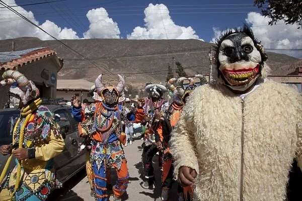 Revellers in costumes and masks at Humahuaca carnival in Jujuy province in the Andes