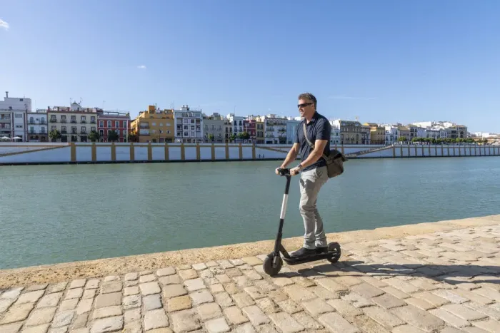 Framed Print : Riding an e-scooter in Seville, Andalusia, Spain, Europe Framed Print : Riding an e-scooter in Seville, Andalusia, Spain, Europe