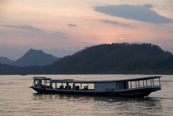 River boat on the Mekong River at sunset, Luang Prabang, Laos, Indochina, Southeast Asia, Asia