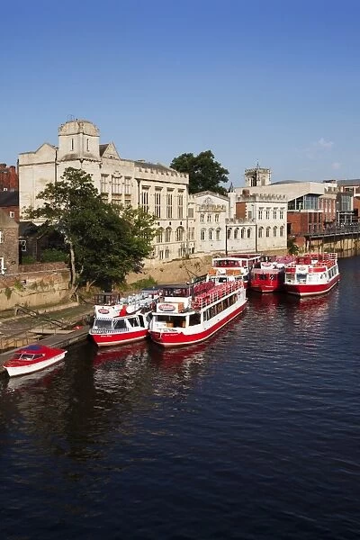 River boats moored on the River Ouse at The Guildhall, City of York, Yorkshire, England, United Kingdom, Europe